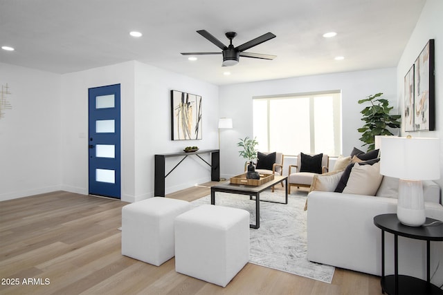 living room with ceiling fan and light wood-type flooring