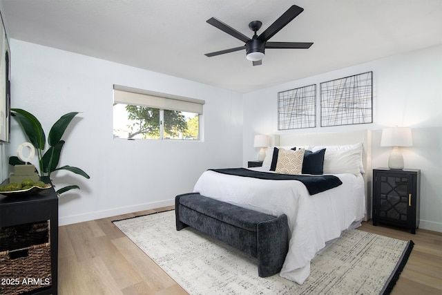 bedroom with ceiling fan and light hardwood / wood-style flooring