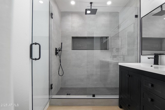 bathroom with vanity and a shower with door