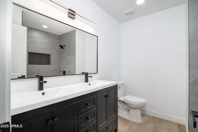 bathroom featuring vanity, hardwood / wood-style floors, and toilet