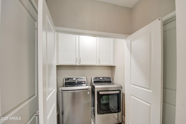 laundry room featuring cabinets and washing machine and clothes dryer