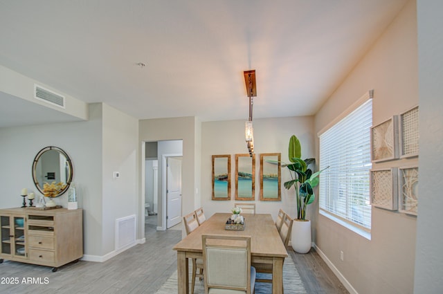 dining space with light hardwood / wood-style floors