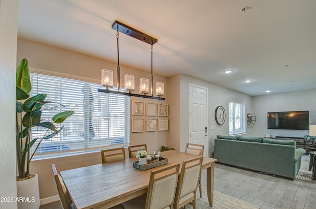 dining area featuring a chandelier and light hardwood / wood-style floors