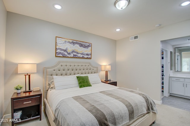 carpeted bedroom featuring connected bathroom