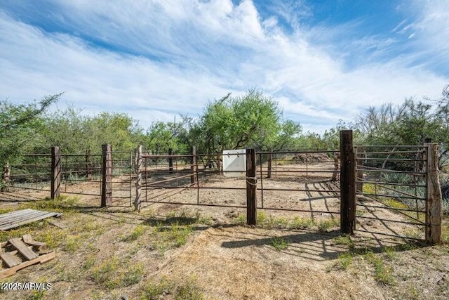 view of gate with a rural view