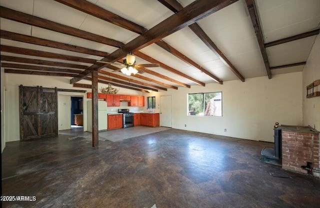 unfurnished living room with a barn door, lofted ceiling with beams, and ceiling fan