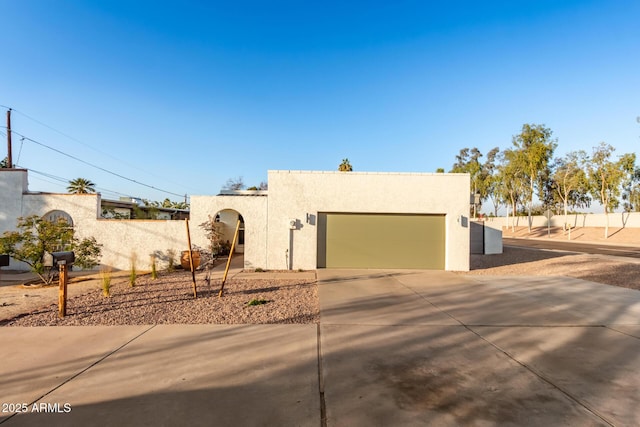 pueblo-style house with a garage