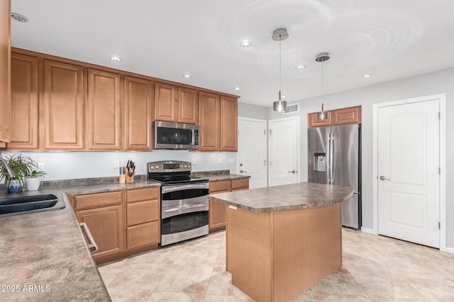 kitchen featuring stainless steel appliances, a center island, sink, and decorative light fixtures