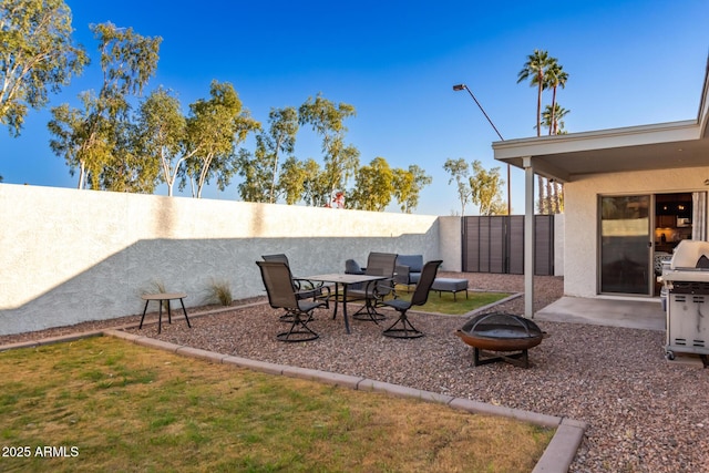 view of yard featuring a patio and an outdoor fire pit