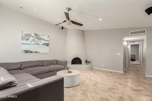 tiled living room featuring a fireplace and ceiling fan