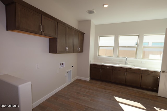 laundry area featuring cabinet space, washer hookup, hookup for an electric dryer, dark wood-style flooring, and recessed lighting