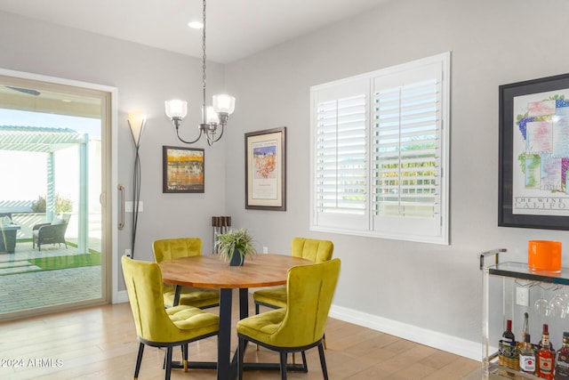 dining room featuring hardwood / wood-style flooring and a chandelier