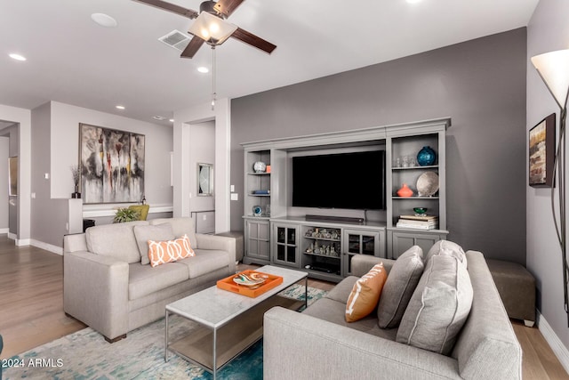 living room with ceiling fan and light wood-type flooring