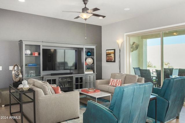 living room featuring light hardwood / wood-style flooring and ceiling fan