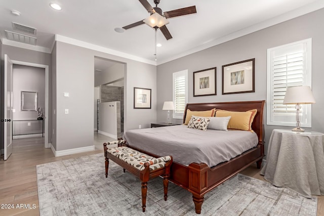 bedroom featuring ceiling fan, light wood-type flooring, and crown molding