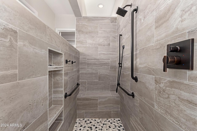 bathroom with tiled shower