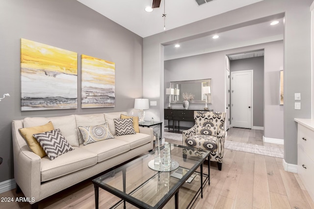 living room with ceiling fan and light hardwood / wood-style floors