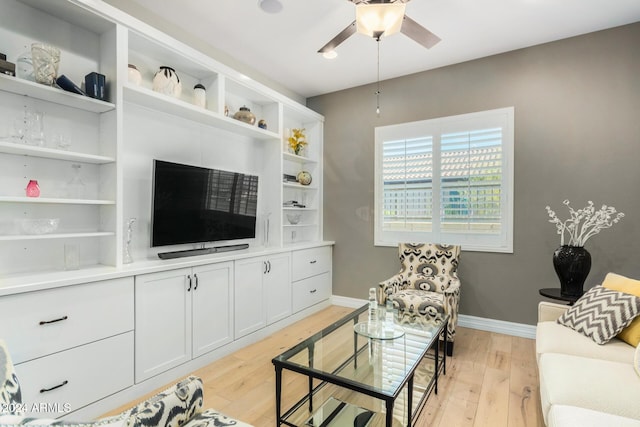 living room with light wood-type flooring and ceiling fan