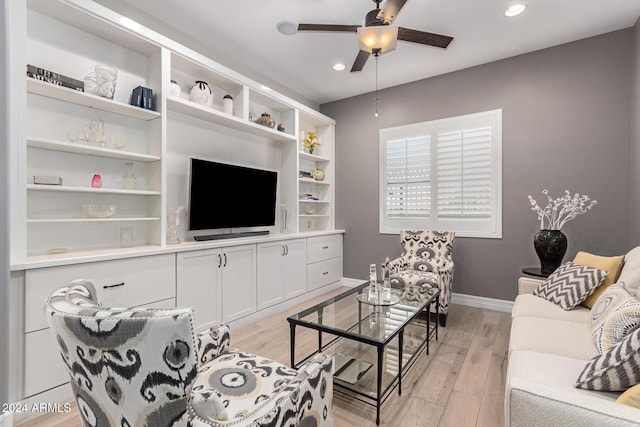 living room featuring ceiling fan and light hardwood / wood-style flooring