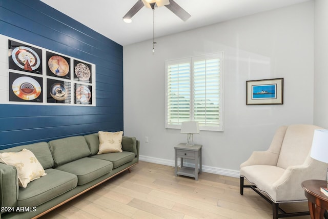 living room featuring ceiling fan and light hardwood / wood-style flooring