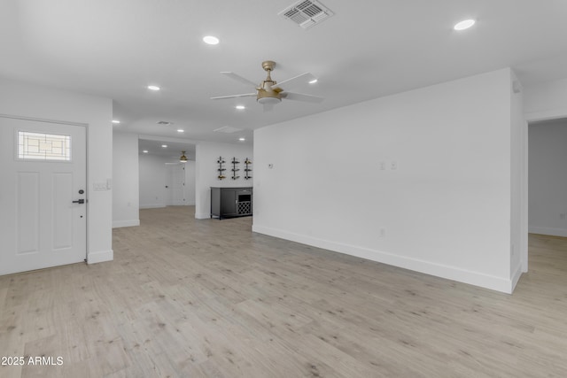 unfurnished living room featuring a ceiling fan, recessed lighting, baseboards, and light wood-style flooring
