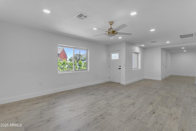 spare room with baseboards, a ceiling fan, recessed lighting, and light wood-style flooring