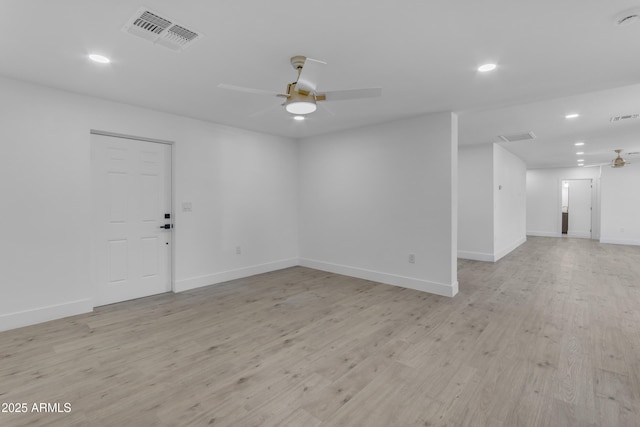 spare room with a ceiling fan, recessed lighting, light wood-style flooring, and baseboards