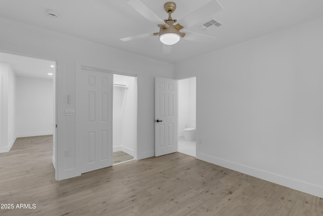 unfurnished bedroom with light wood-type flooring, baseboards, a closet, and a ceiling fan