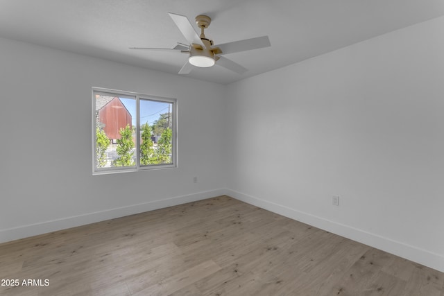 unfurnished room featuring baseboards, light wood finished floors, and a ceiling fan