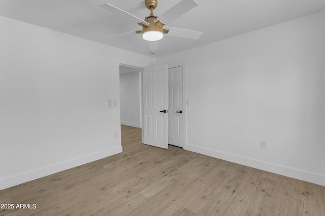 unfurnished room with ceiling fan, baseboards, and wood finished floors