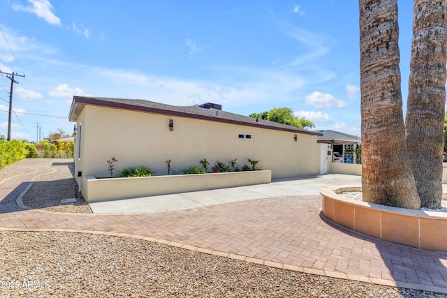view of side of home with stucco siding