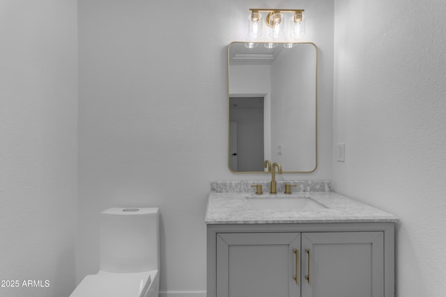 half bathroom with vanity and toilet