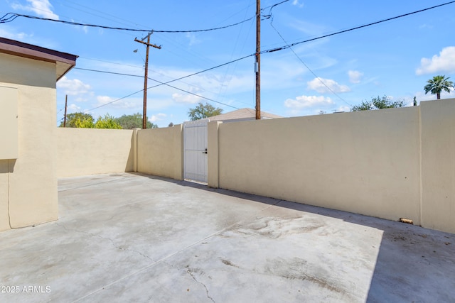 view of patio with a gate and fence