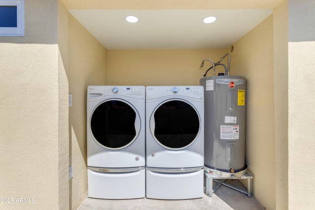 laundry area featuring water heater, separate washer and dryer, and recessed lighting
