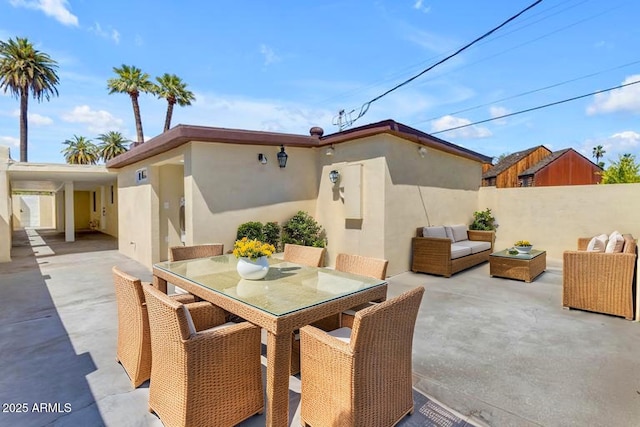 view of patio featuring fence, an outdoor hangout area, and outdoor dining area