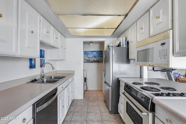 kitchen featuring white appliances, white cabinets, light countertops, a sink, and light tile patterned flooring