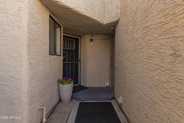 property entrance featuring stucco siding