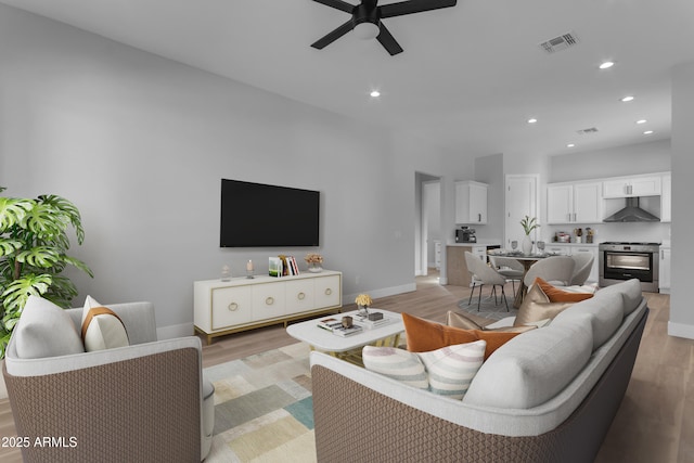 living room featuring ceiling fan and light wood-type flooring