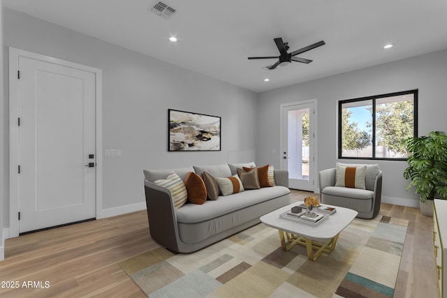 living room featuring ceiling fan and light wood-type flooring