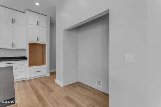 kitchen with white cabinetry and light hardwood / wood-style floors