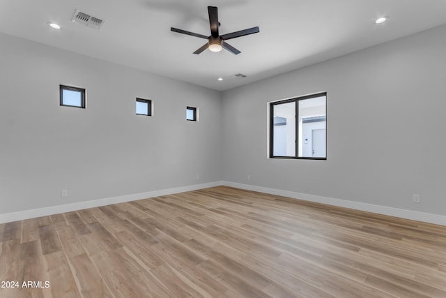 empty room with ceiling fan and light wood-type flooring