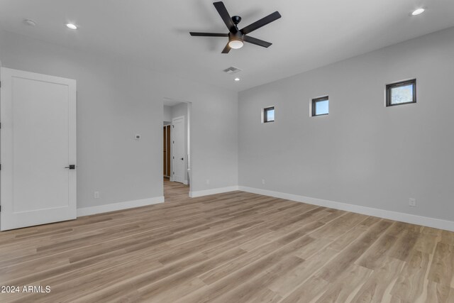 spare room with ceiling fan and light wood-type flooring