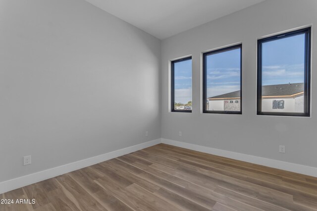 unfurnished room featuring hardwood / wood-style floors