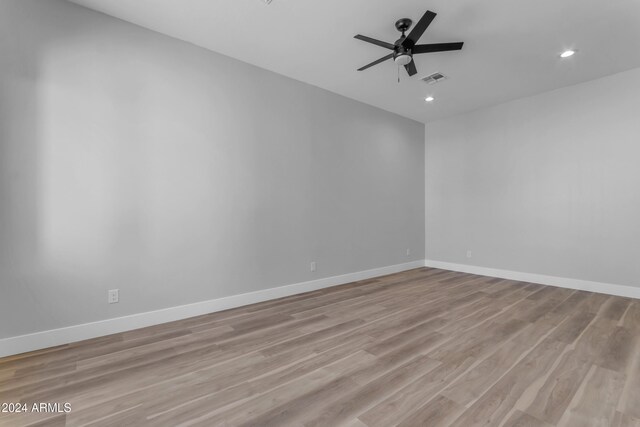 empty room with light hardwood / wood-style flooring and ceiling fan