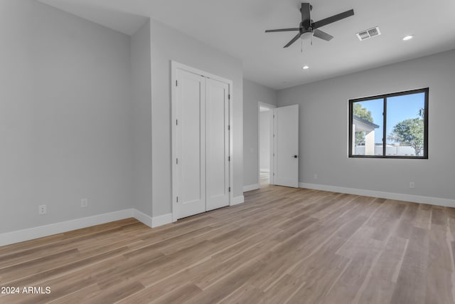 unfurnished bedroom featuring a closet and light hardwood / wood-style flooring