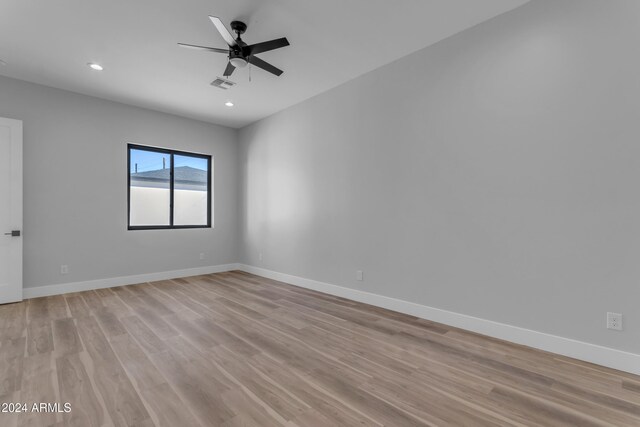 empty room with light hardwood / wood-style flooring and ceiling fan