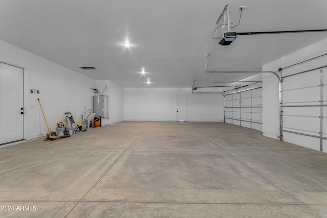 garage with a garage door opener and water heater