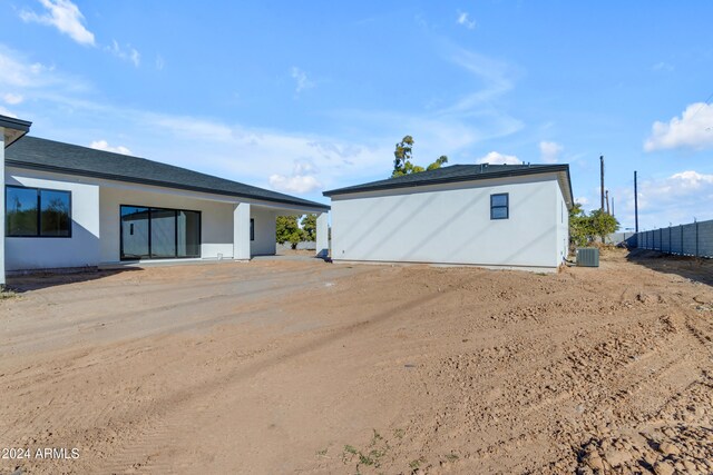 back of house with central air condition unit