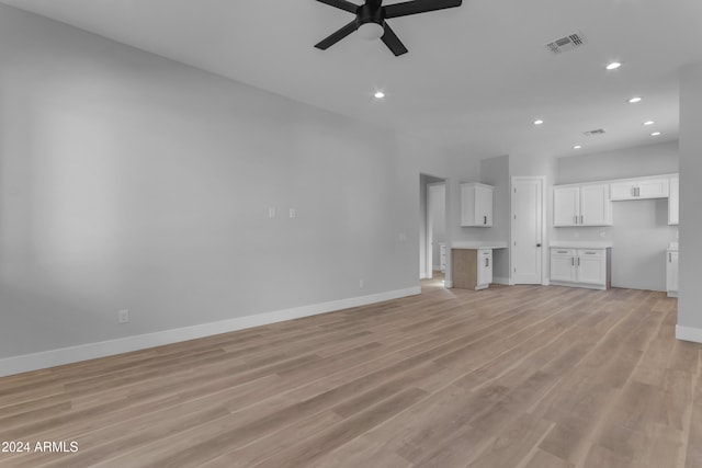 unfurnished living room featuring ceiling fan and light hardwood / wood-style flooring