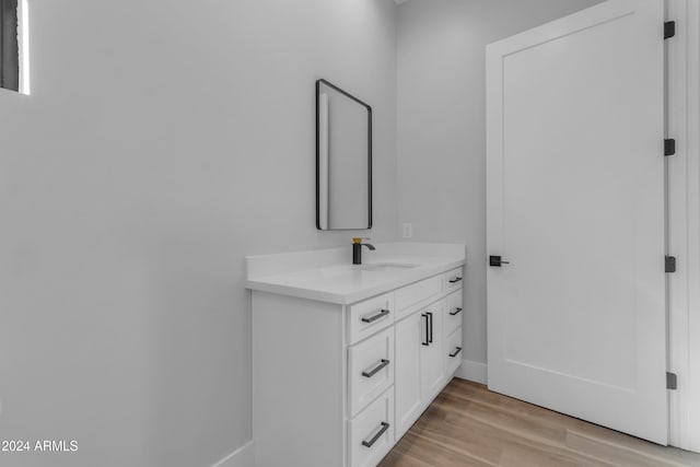 bathroom with vanity and hardwood / wood-style flooring